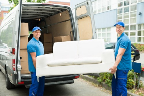 Moving van and helper loading household items safely