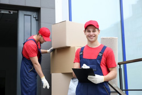 Trained movers handling furniture with care and proper lifting technique