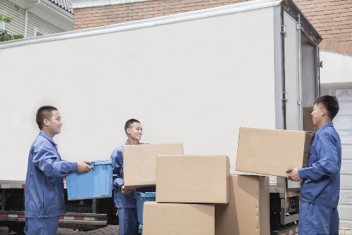 Moving team lifting furniture safely during a relocation