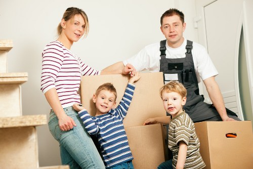 Specialist movers wrapping and preparing a piano for safe removal in Haringey