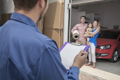 Moving team handling furniture carefully during a van loading operation